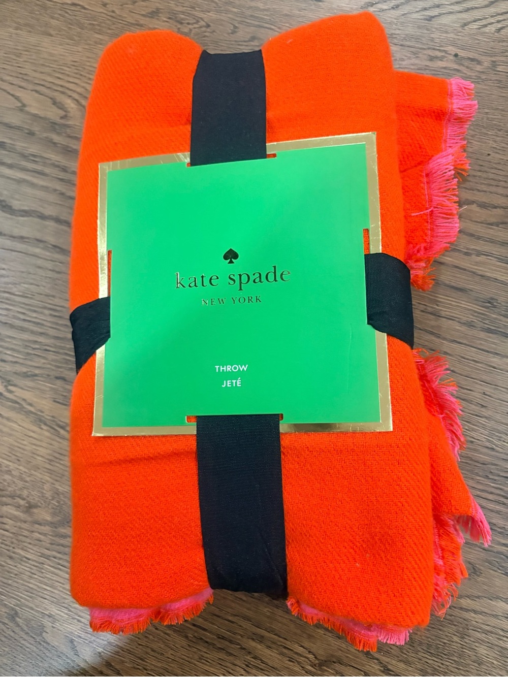 kate spade Vibrant Orange Throw with pink fringe